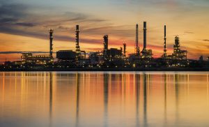 petrochemical plant in night time with reflection over the river