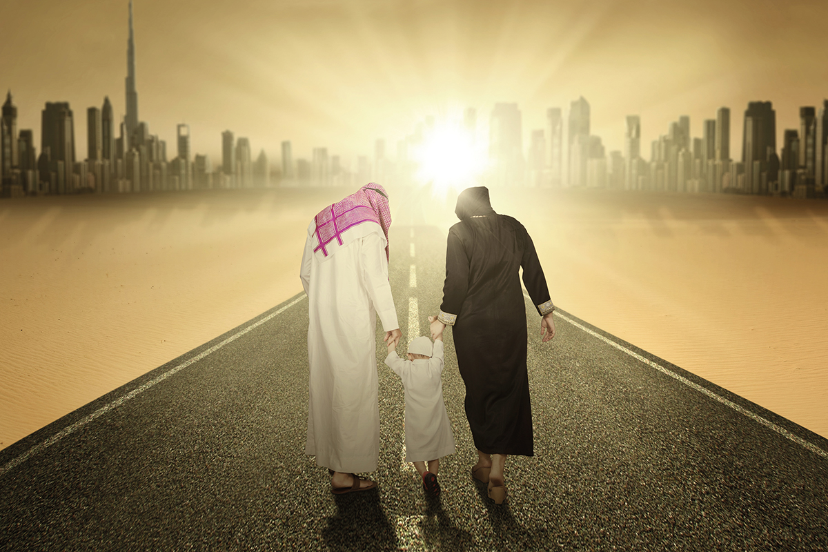 Rear view of arabic family walking on the highway while holding hands
